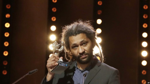 Alain Gomis tient sa récompense à Berlin, Allemagne, le 18 février 2017.