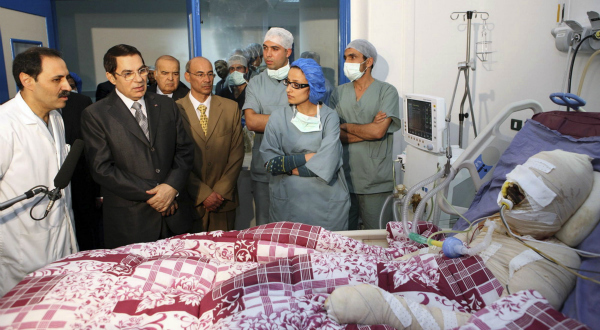 1. L'ancien président tunisien Zine el-Abidine Ben Ali pose à côté de Mohamed Bouazizi, le 28 décembre 2010, à l'hopital de Ben Arous, près de Tunis. Il tente ainsi d'afficher son soutien afin d'apaiser le mouvement de protestation qui est né de l'immolation par le feu de ce jeune homme, décédé quelques jours plus tard, le 4 janvier 2011. REUTERS/Présidence tunisienne.