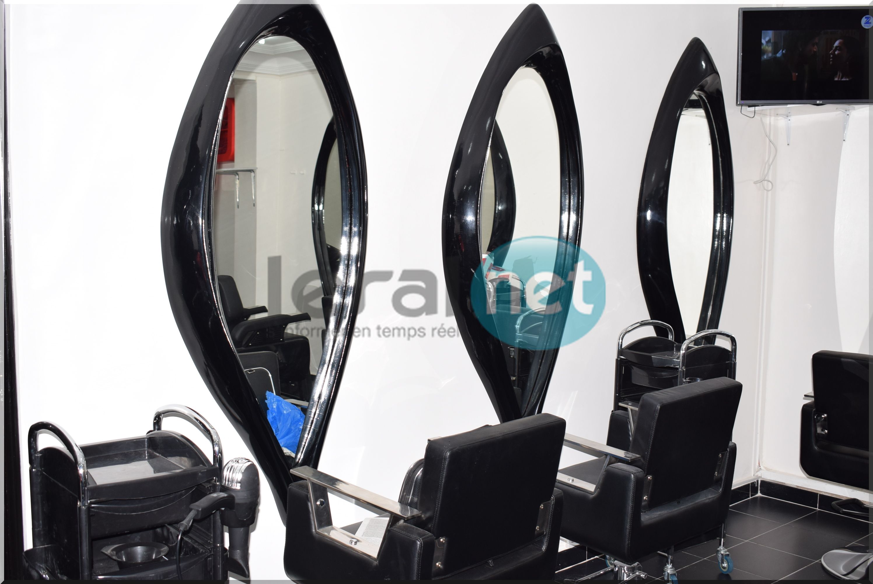 Taco Afro Coiffure, un salon de coiffure afro et d’esthétique moderne, du gris anthracite et noir, au décor design et aux murs ornés de grands miroirs.