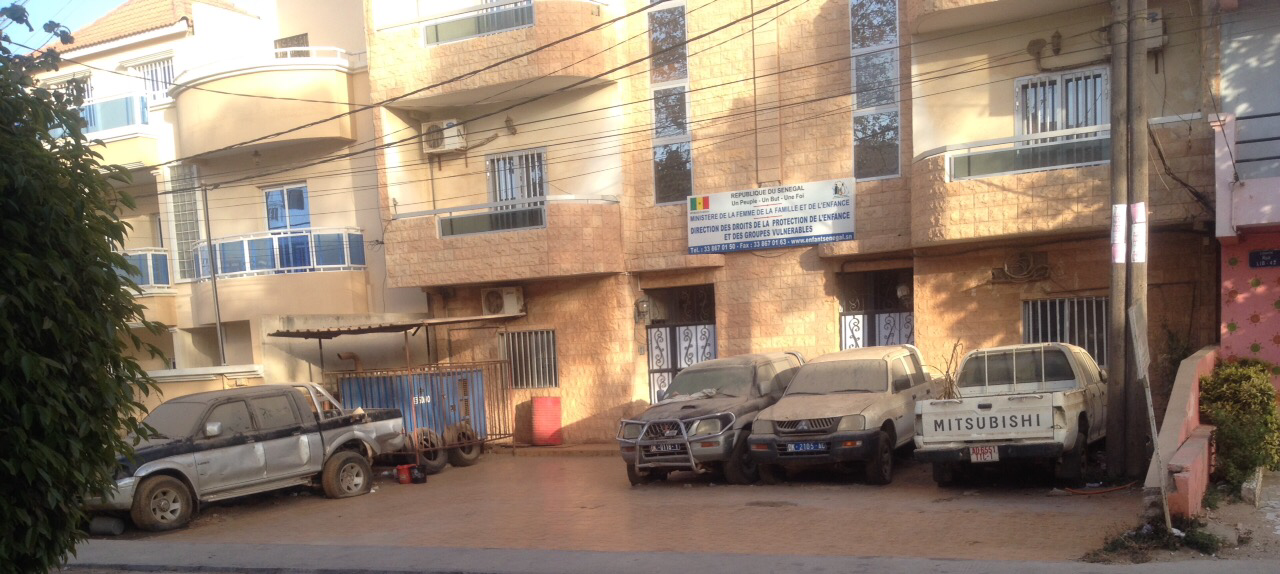 Cimetière de voitures devant un bâtiment officiel - Cela se passe au Sénégal !