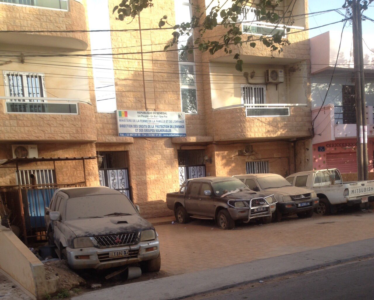 Cimetière de voitures devant un bâtiment officiel - Cela se passe au Sénégal !
